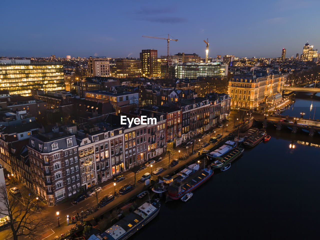 High angle view of illuminated buildings in city at night in amsterdam