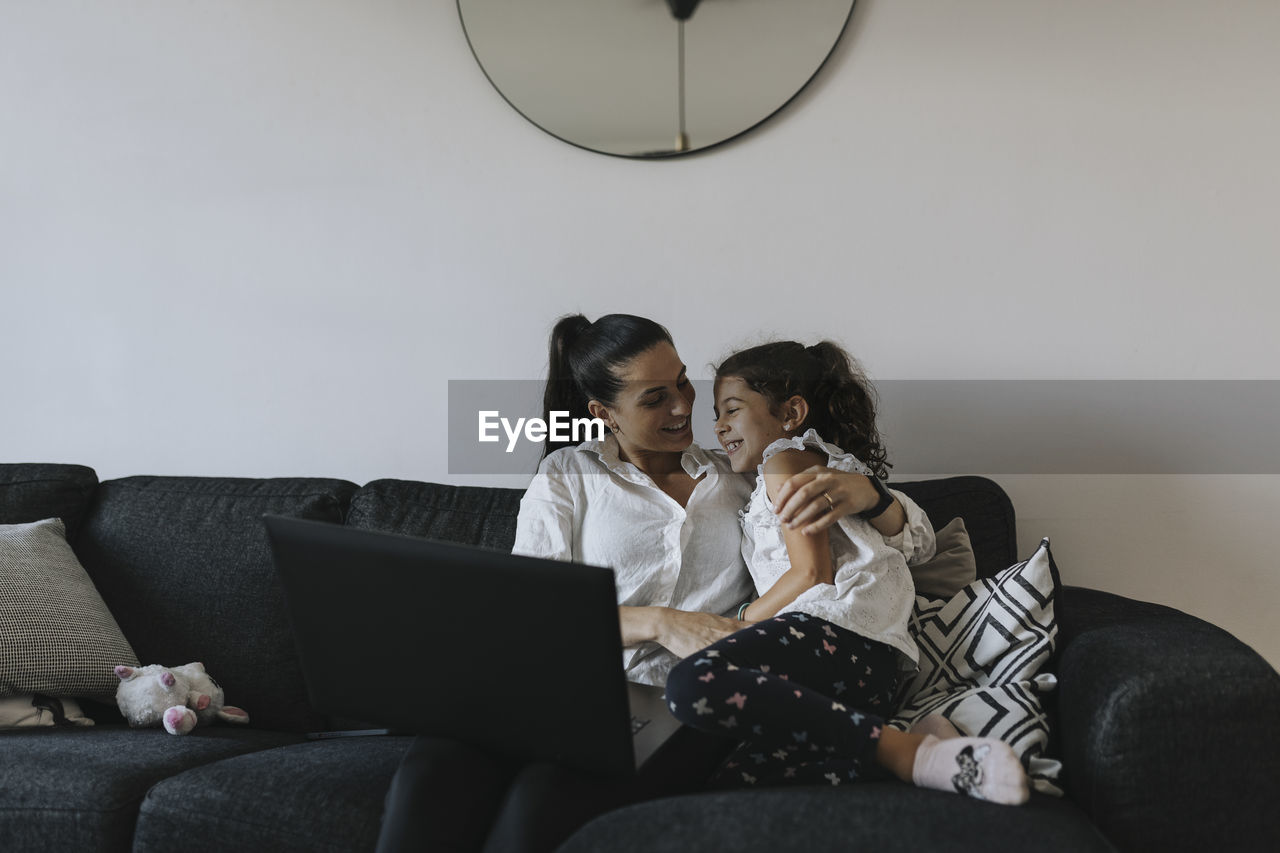 Mother and daughter on sofa