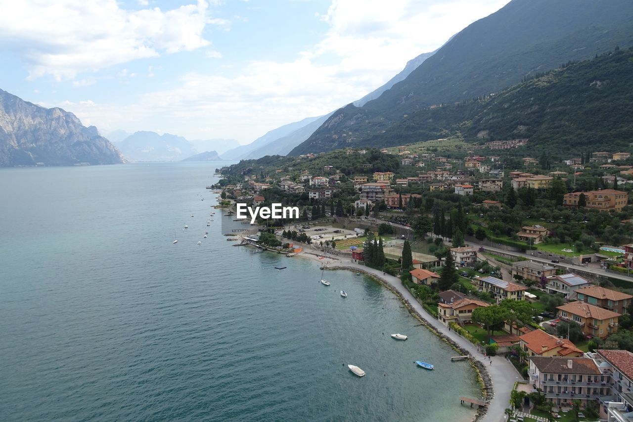 SCENIC VIEW OF SEA BY CITY AGAINST SKY