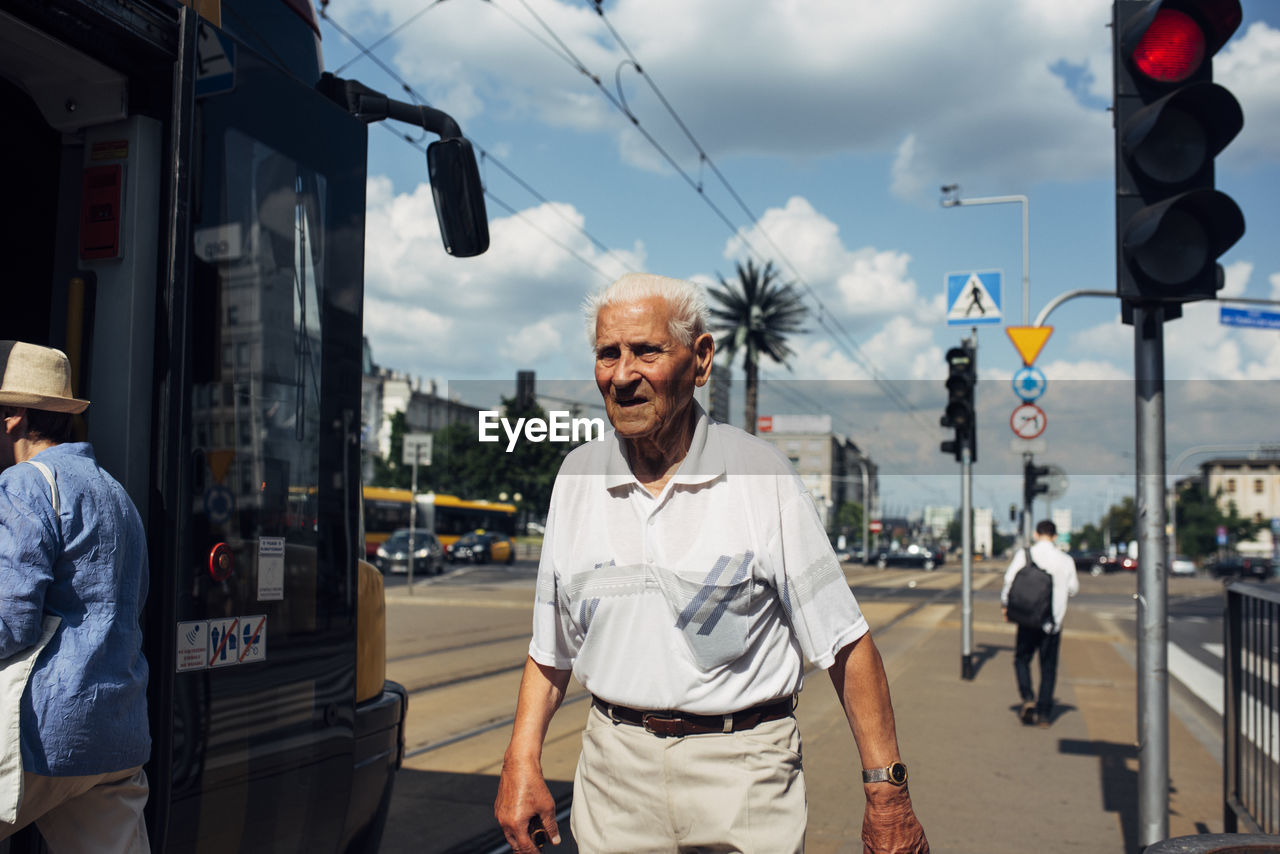 MAN STANDING ON STREET