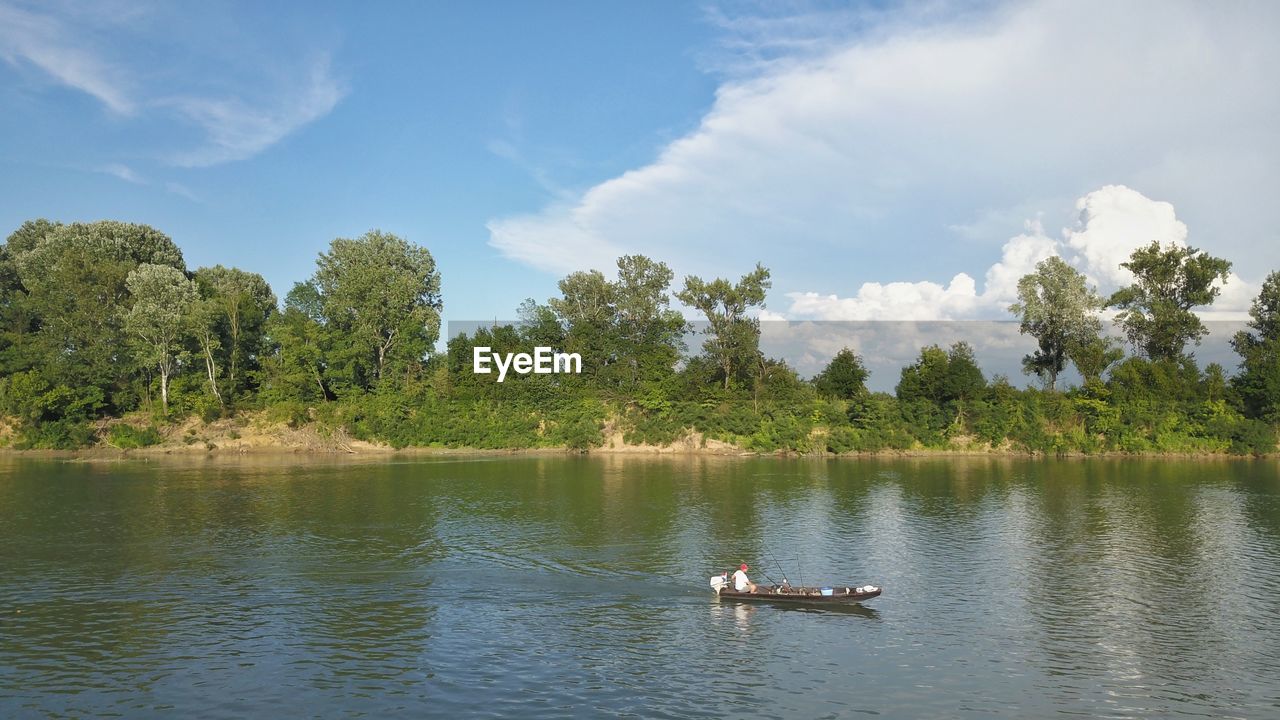 SCENIC VIEW OF LAKE AGAINST TREES