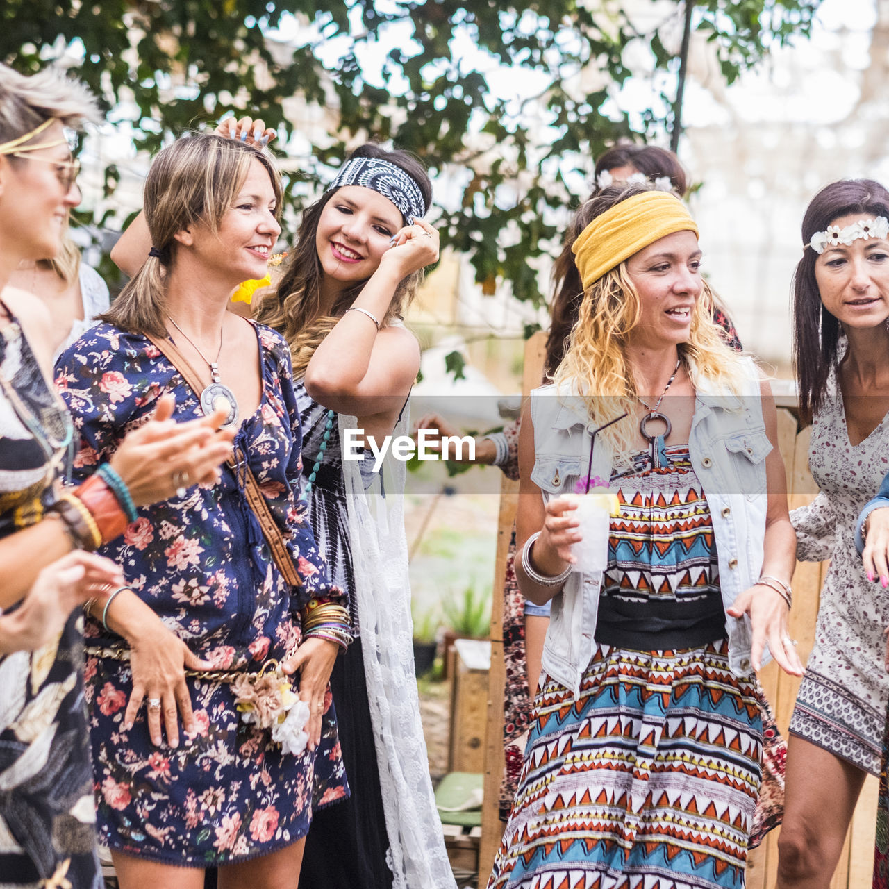 Mid adult hipster women dancing on field