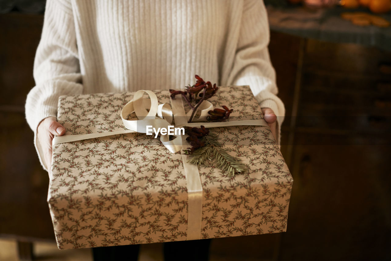 Woman holding wrapped christmas present