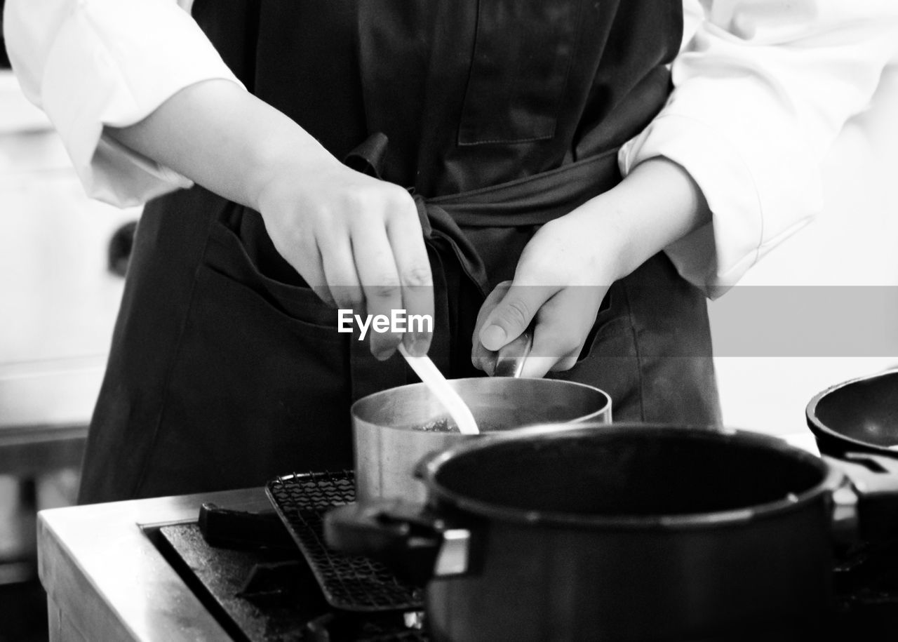 MIDSECTION OF MAN PREPARING FOOD