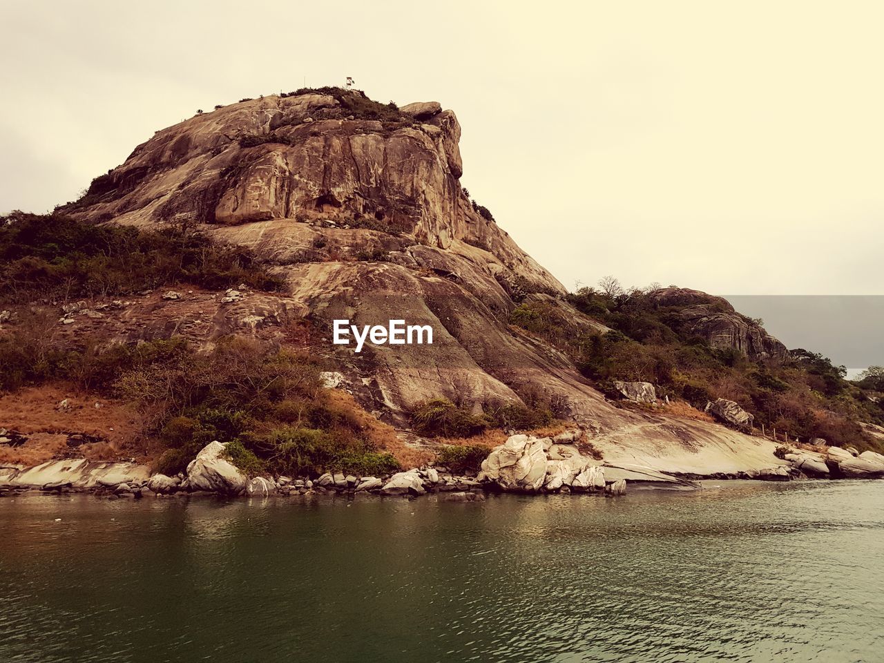 Scenic view of rock formation in sea against sky