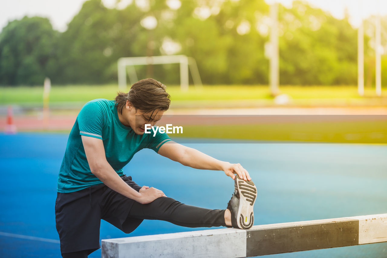 Young man exercising at stadium