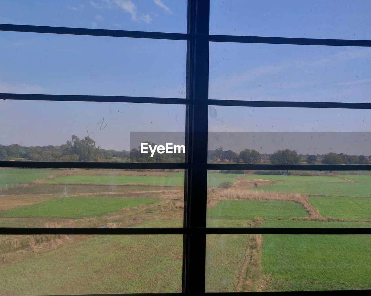 LANDSCAPE SEEN THROUGH GLASS WINDOW