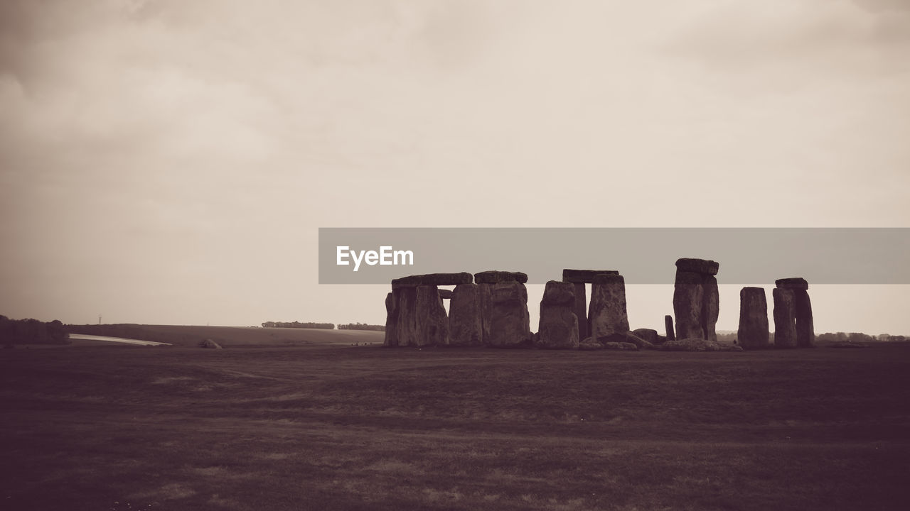 Stonehenge on grass against sky