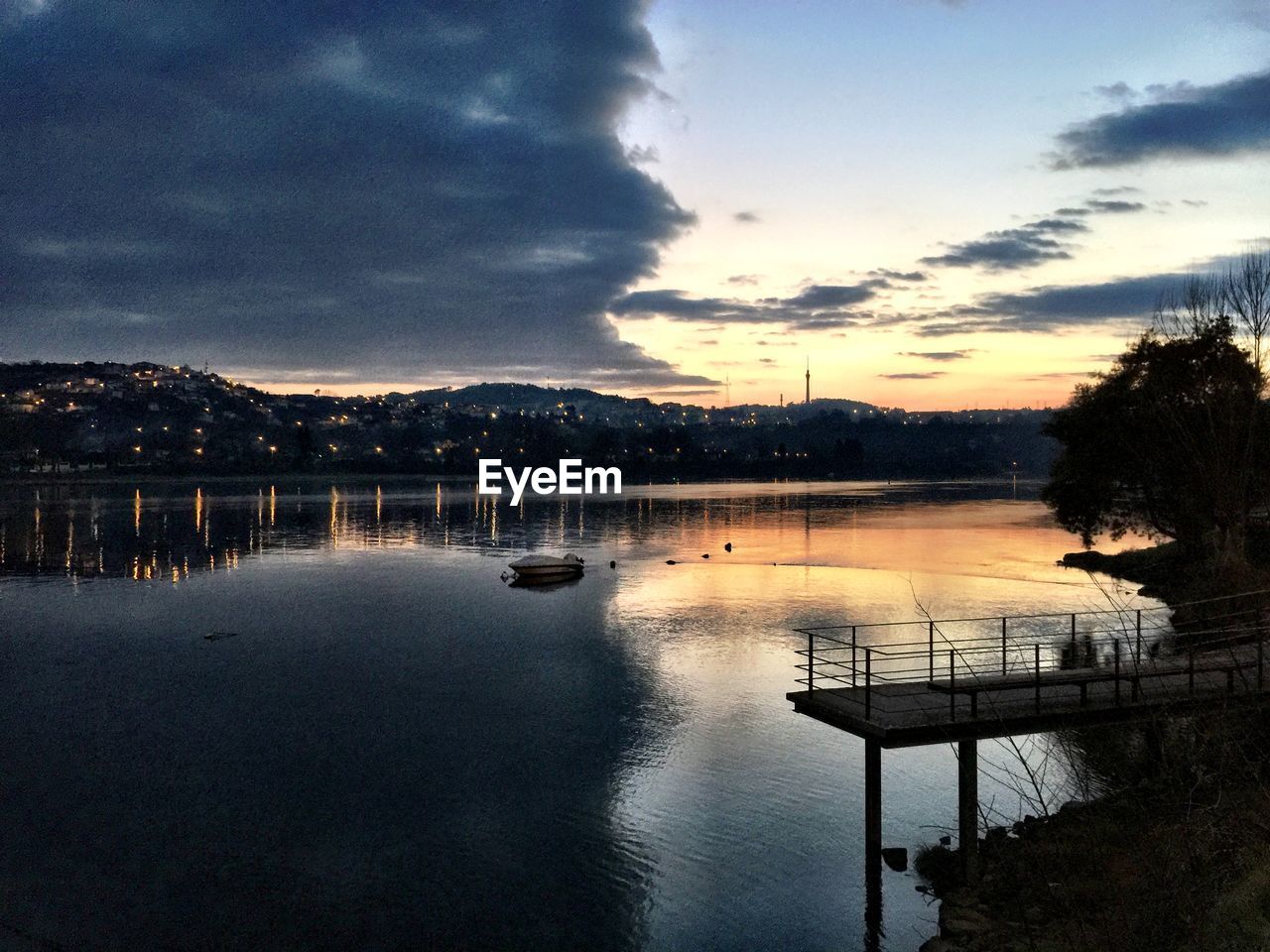 Cloudy sky above lake at dusk