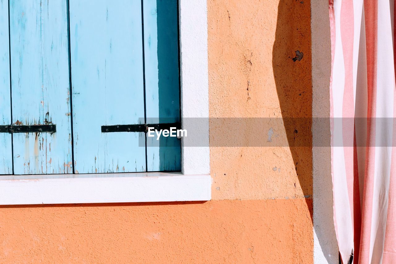 CLOSED BLUE WINDOW OF BUILDING