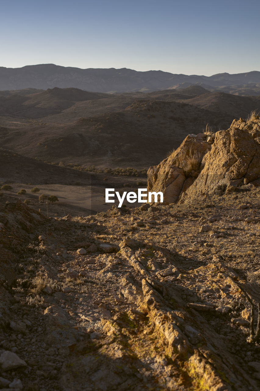 Scenic view of arid landscape against sky