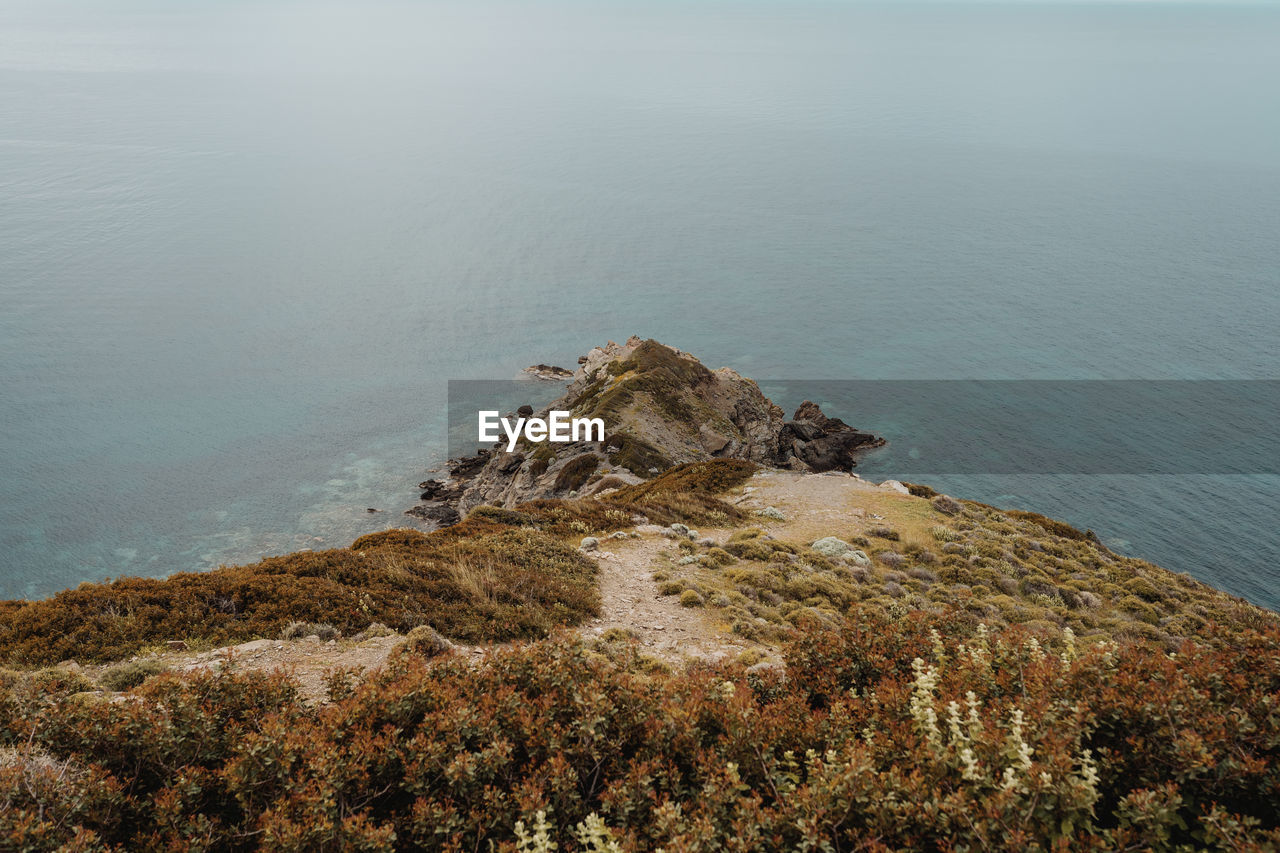 High angle view of mountain against sea