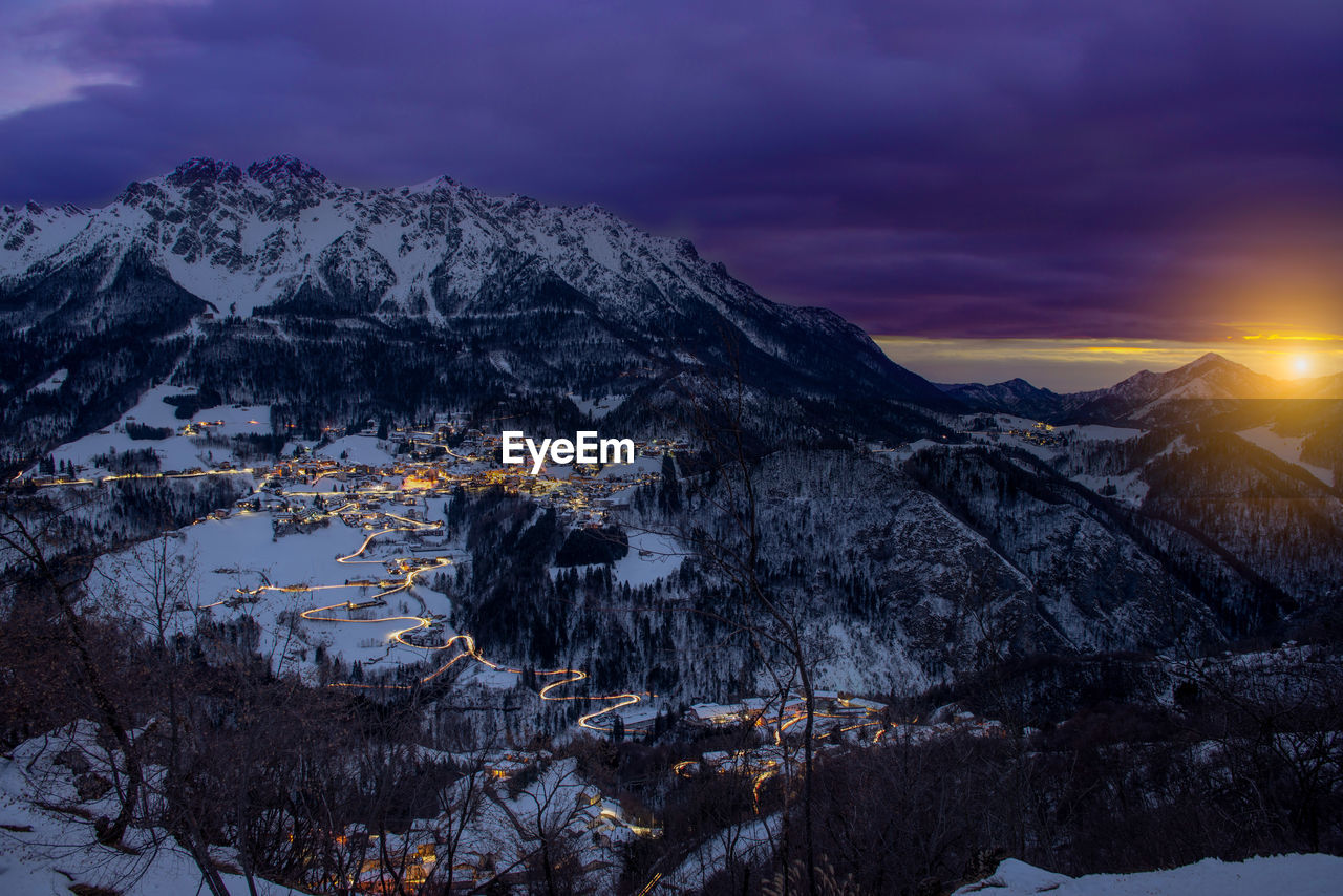 Scenic view of snowcapped mountains against sky during sunset