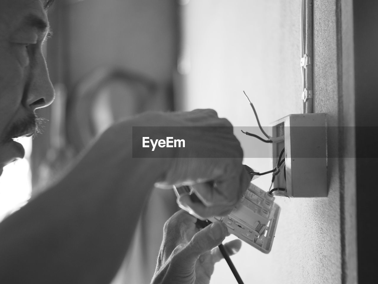 CLOSE-UP OF HANDS WORKING ON MIRROR