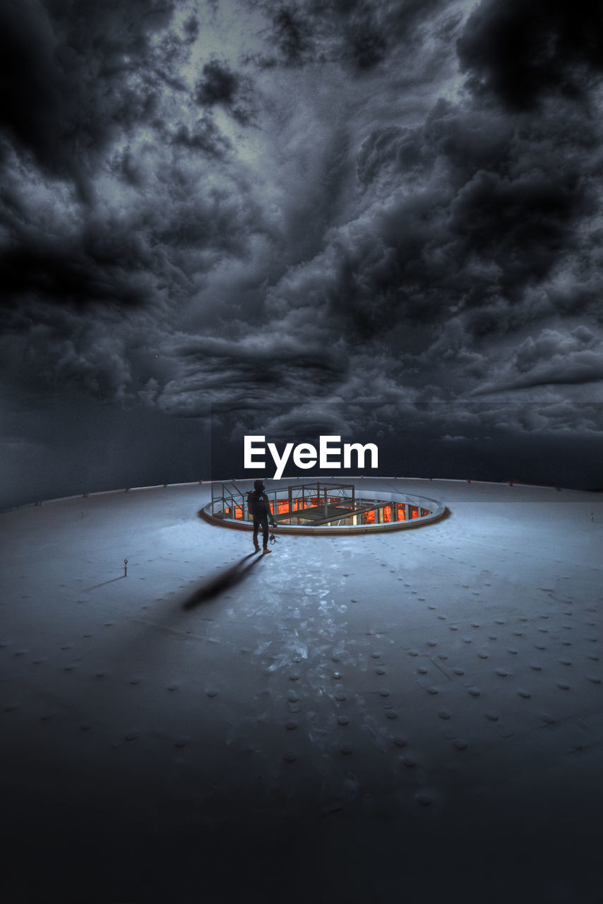 BOAT ON SEA AGAINST STORM CLOUDS