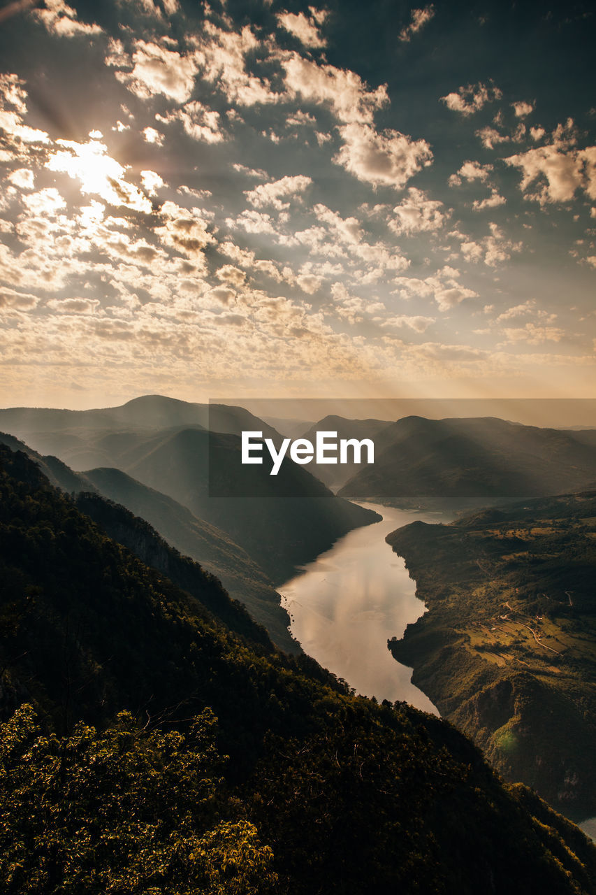 Scenic view of mountains against sky at sunset