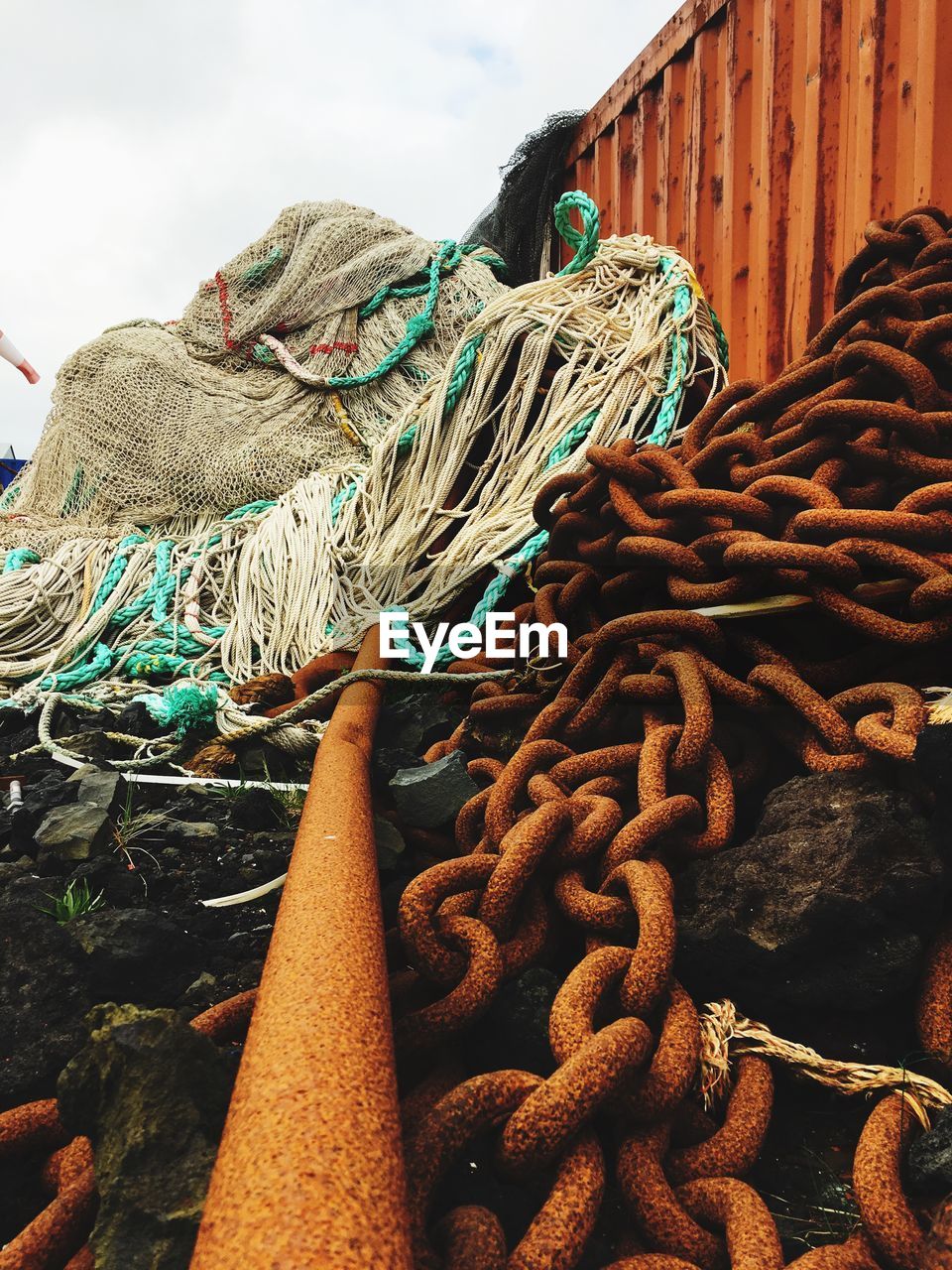 CLOSE-UP OF FISHING NET ON RUSTY METAL