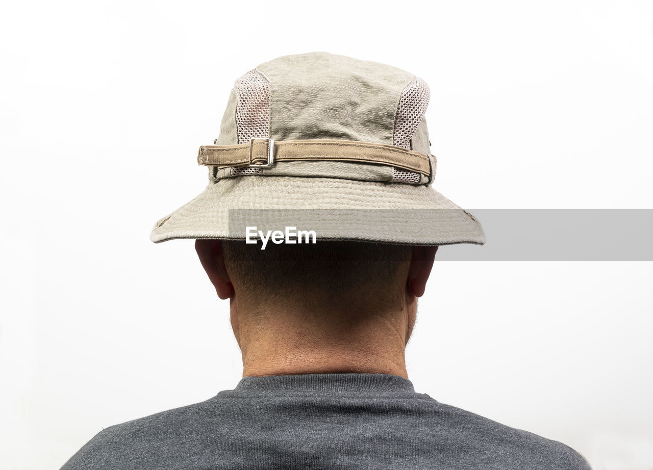 REAR VIEW OF MAN AGAINST WHITE BACKGROUND