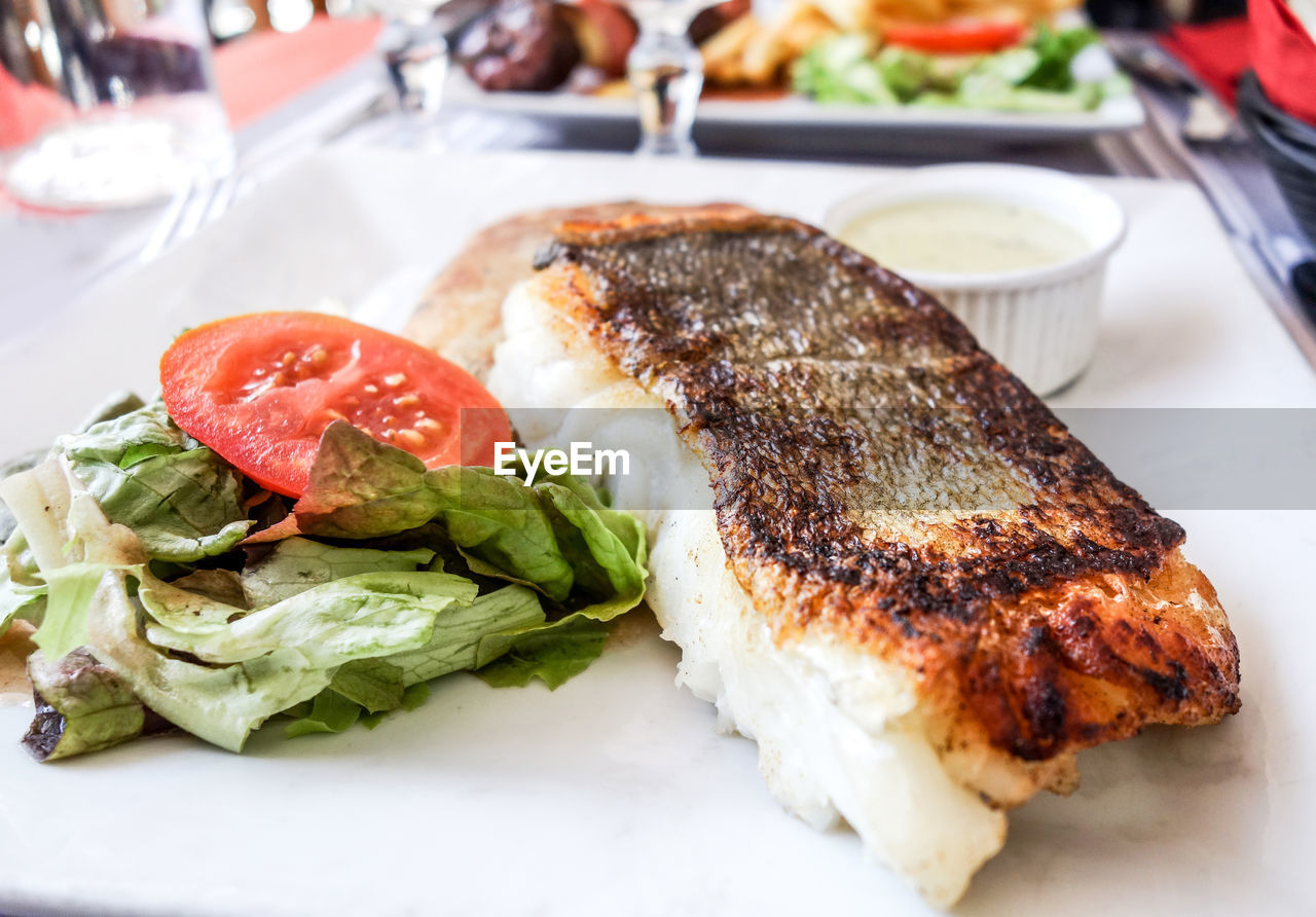 Grilled fish steak with salad