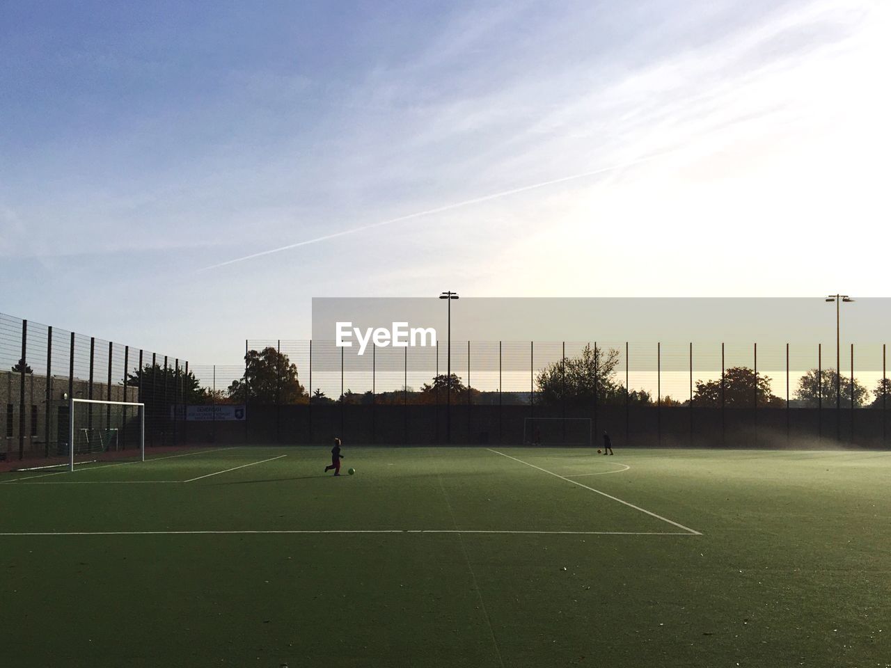 Boys playing soccer on field