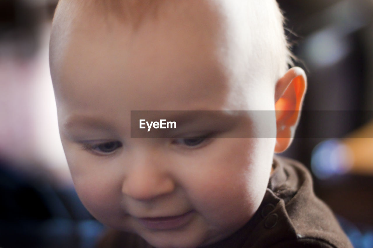 Close-up of cute baby boy looking down