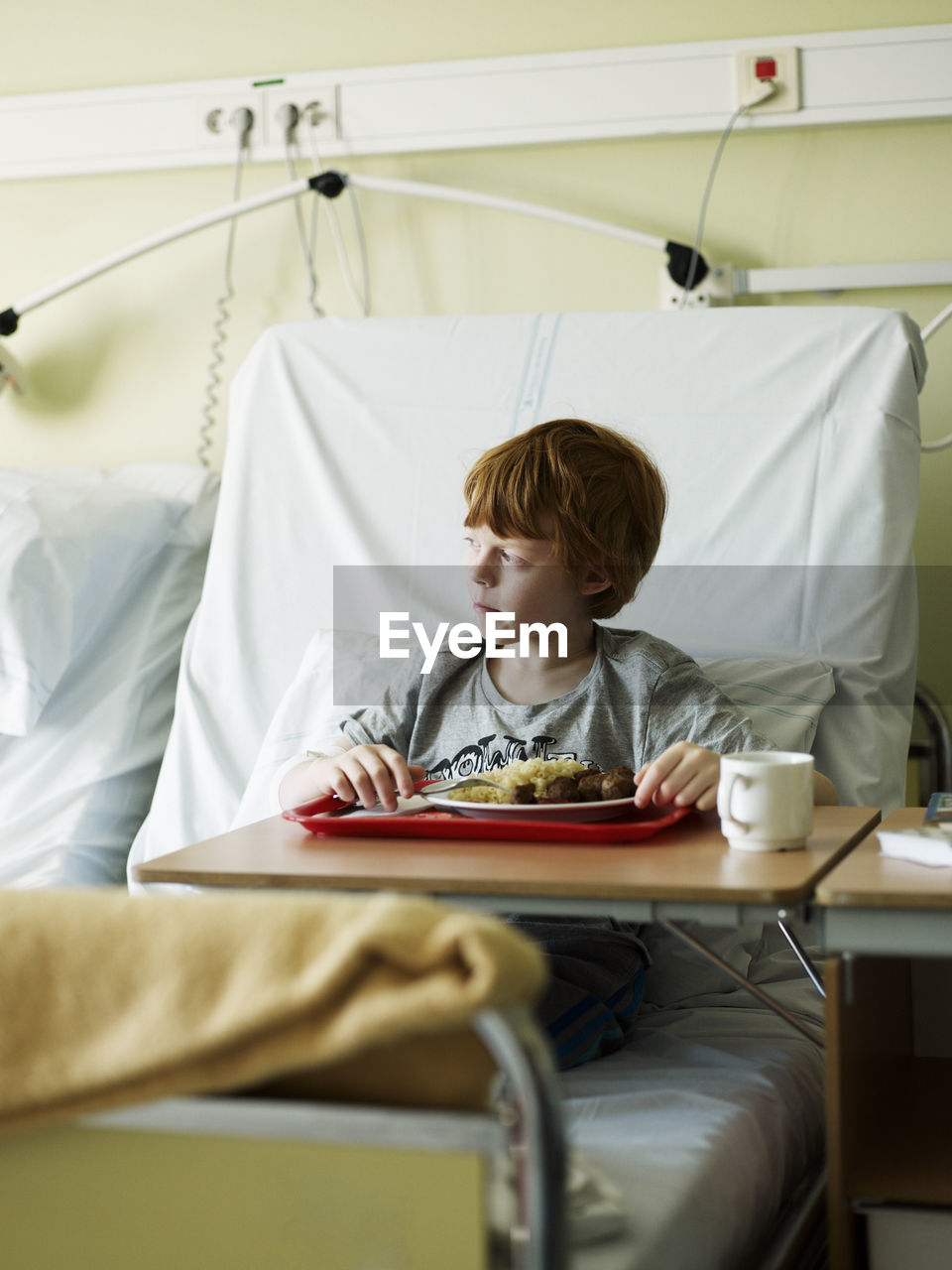 Boy eating meal in hospital