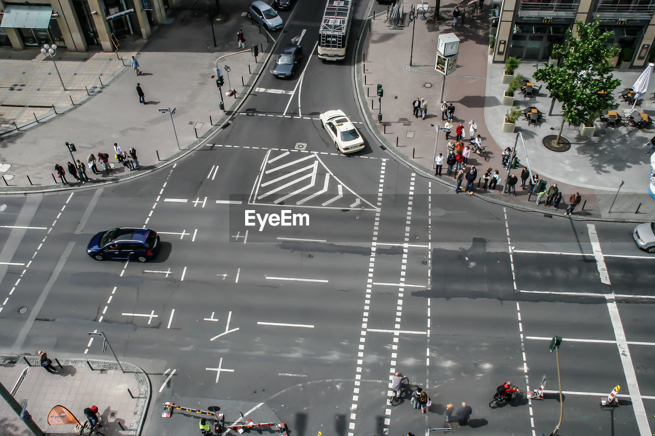 High angle view of people walking on road