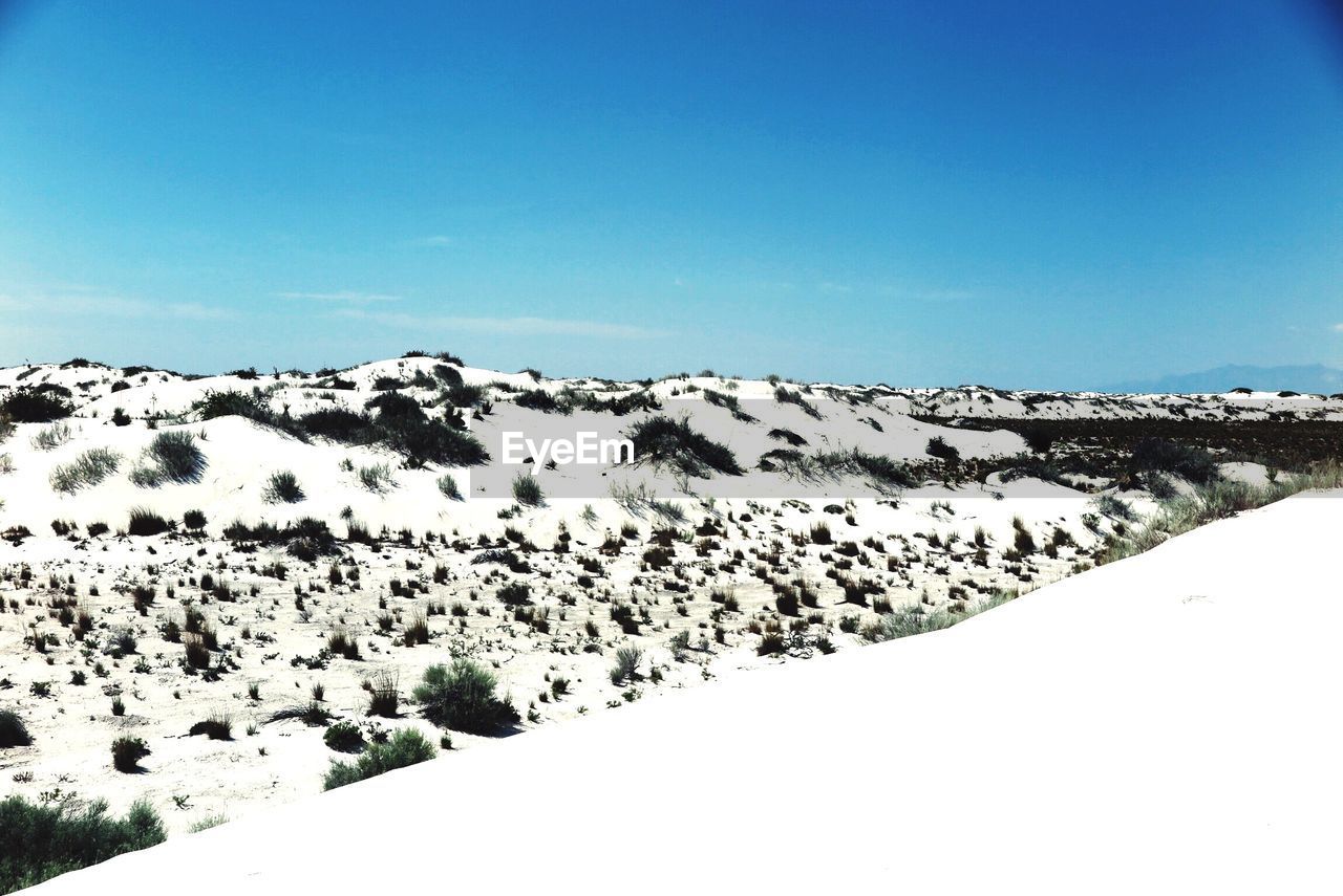 Scenic view of snow covered field against clear sky