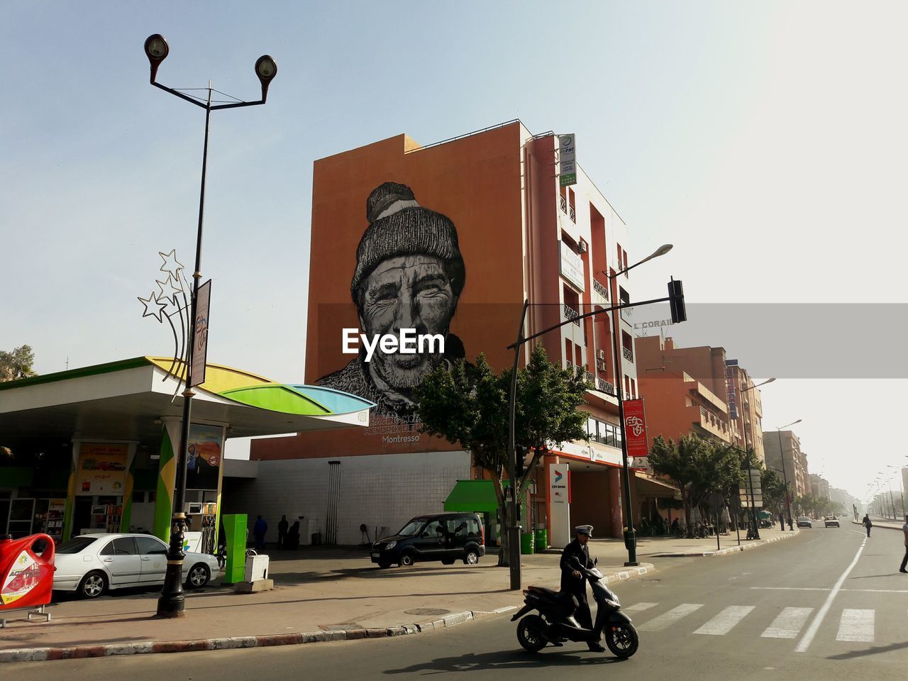 View of city street against blue sky
