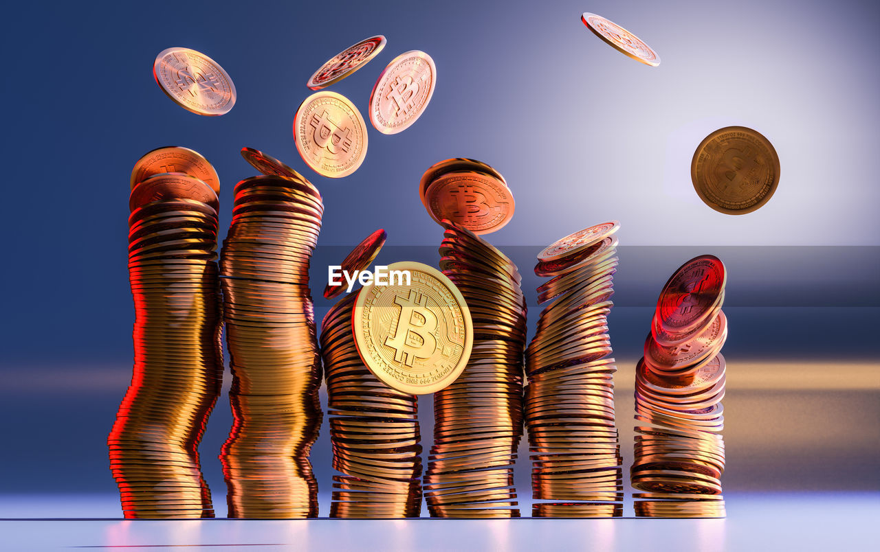 LOW ANGLE VIEW OF COINS ON METALLIC STRUCTURE