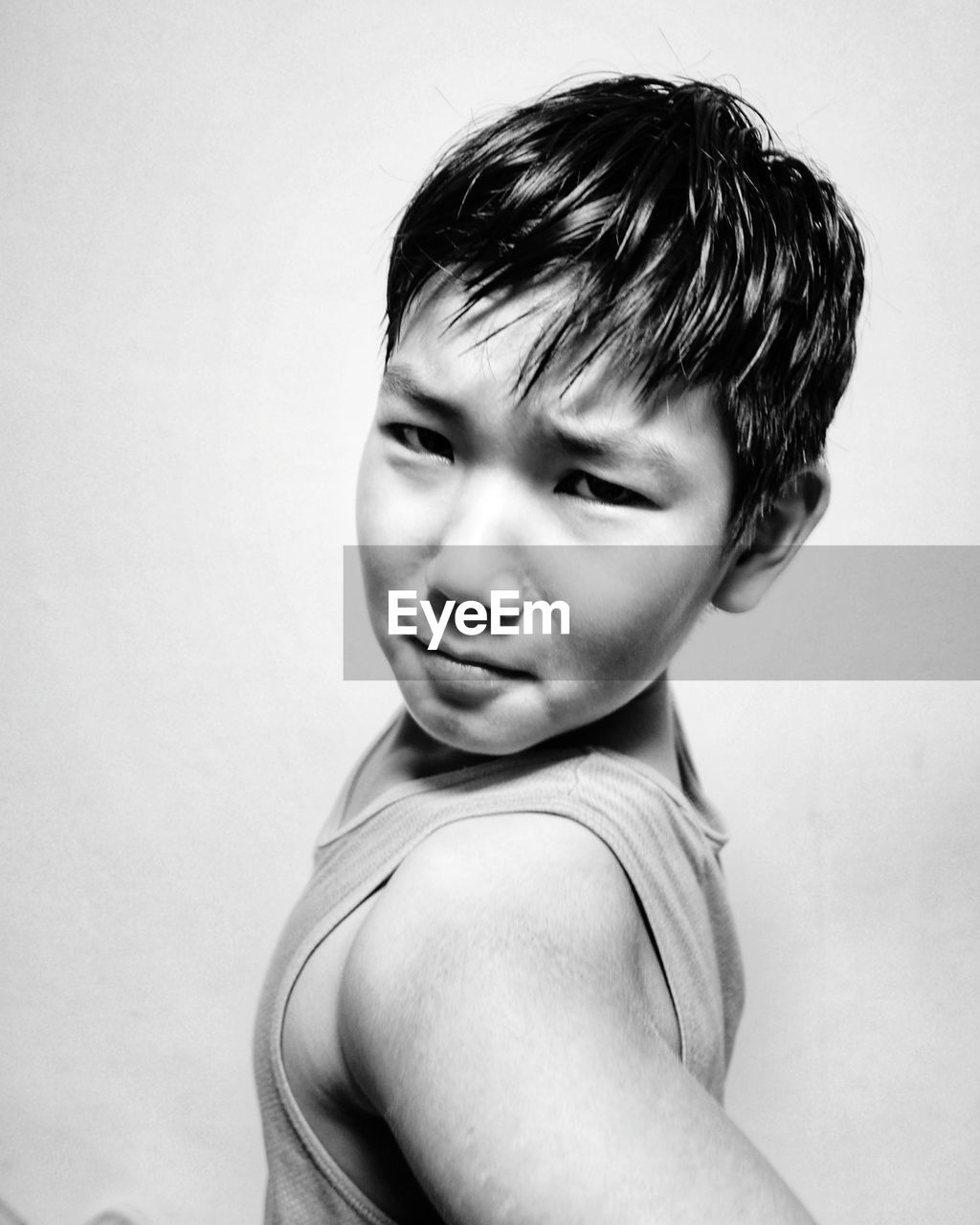 Portrait of boy by white background