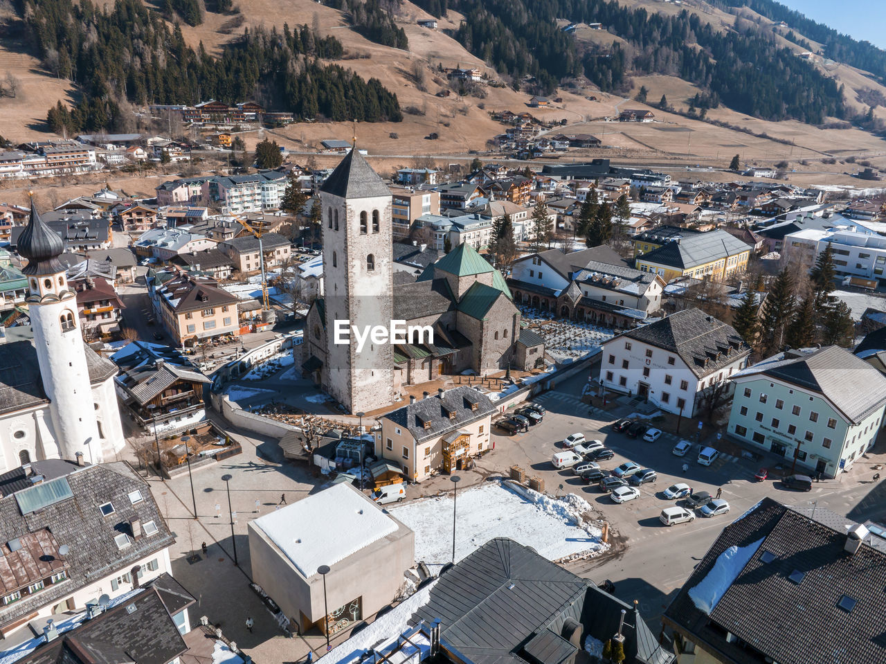 High angle view of townscape against mountain on sunny day during winter