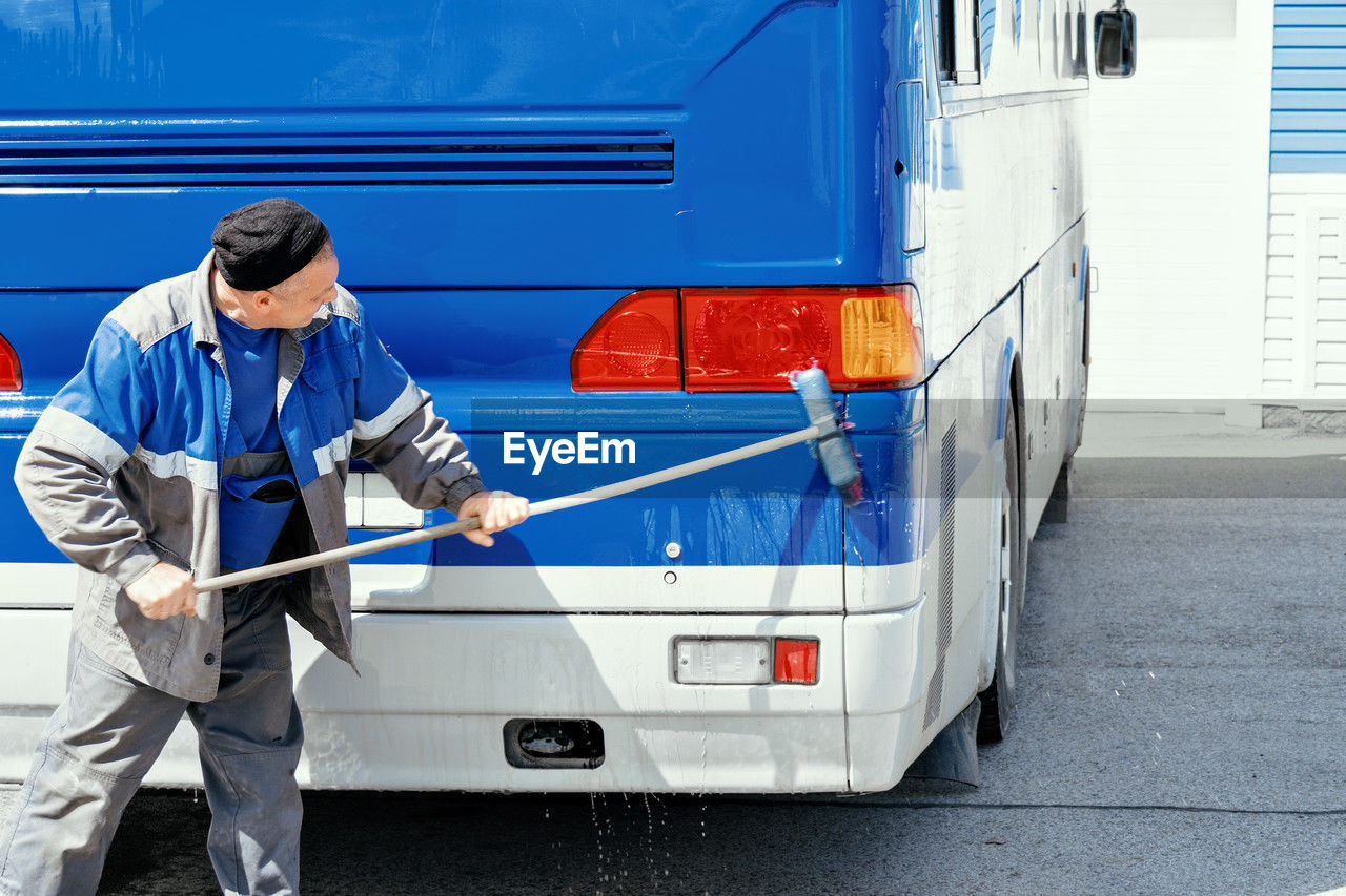 rear view of man working on railroad station