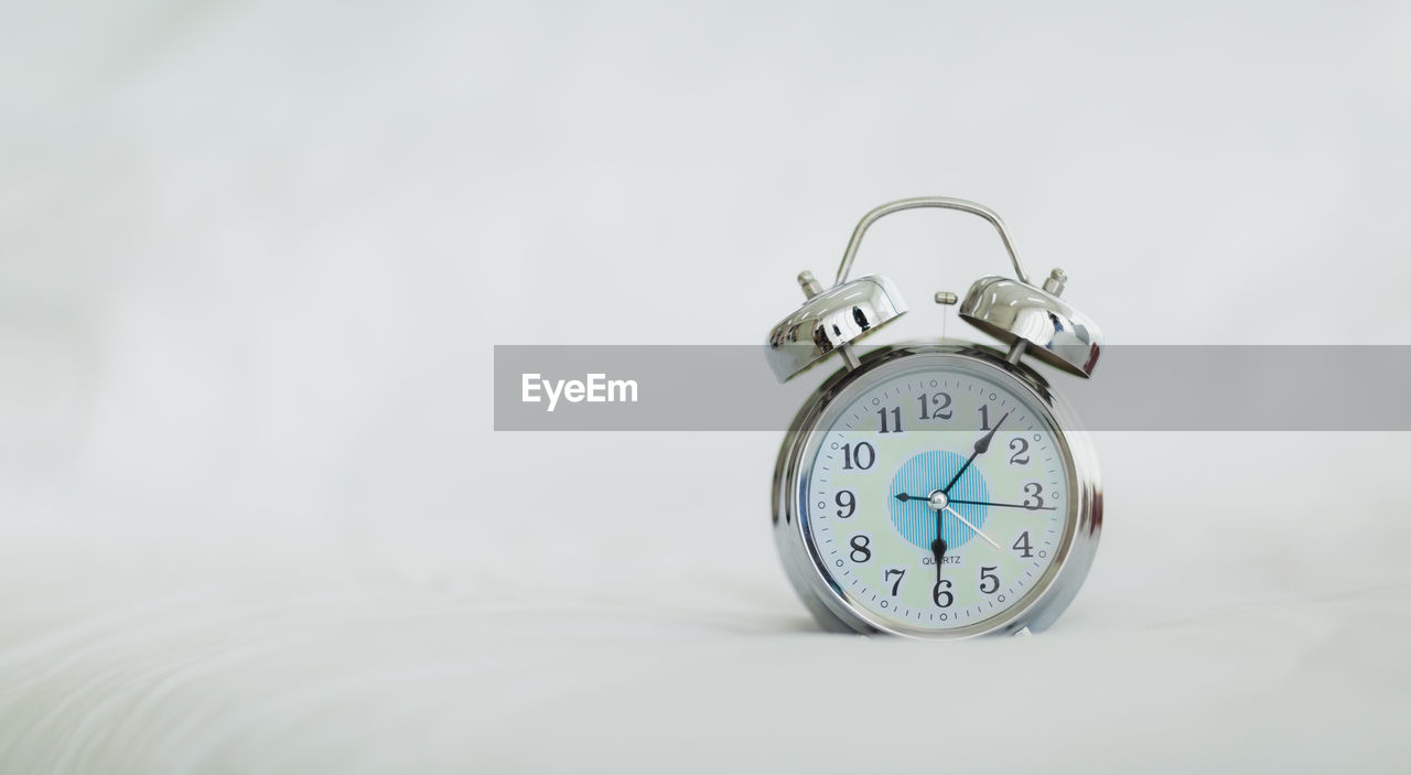 CLOSE-UP OF CLOCK ON THE TABLE