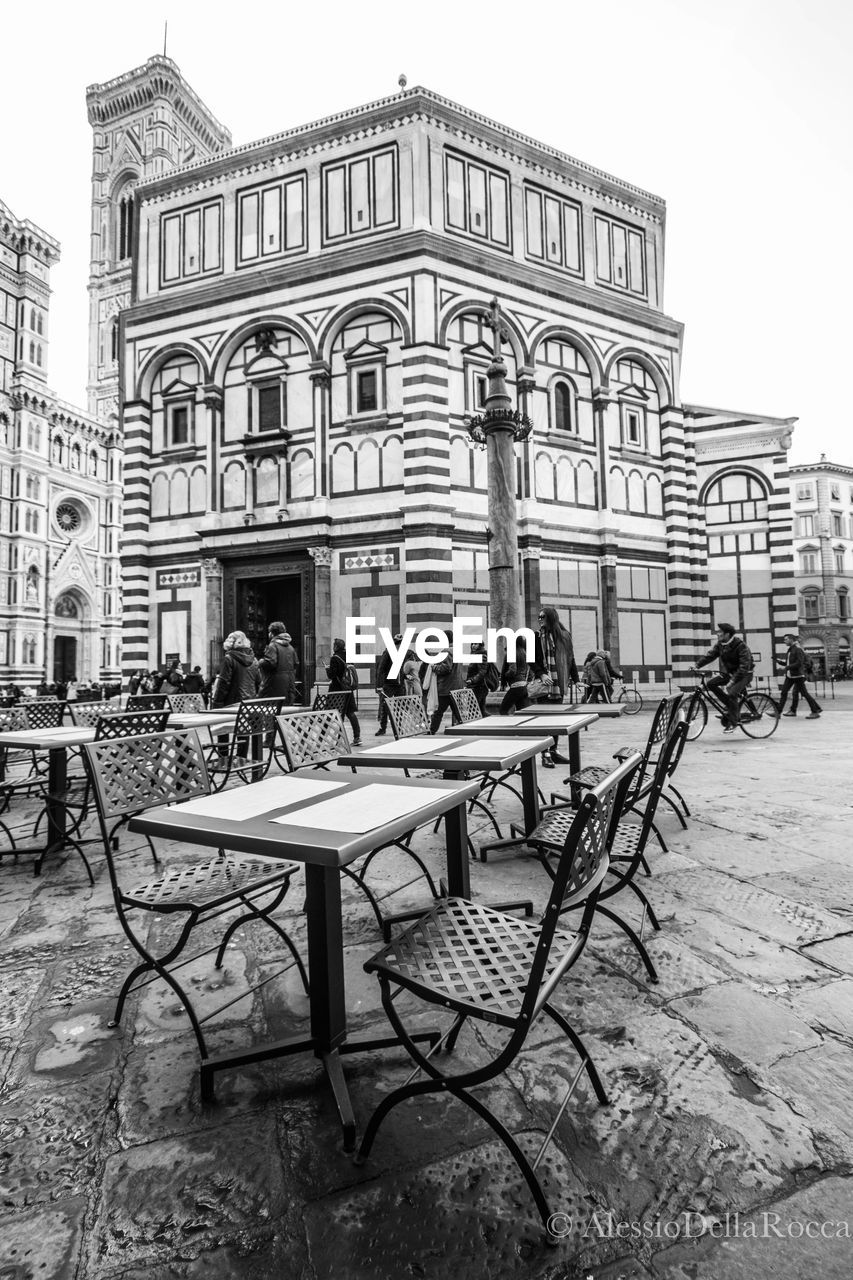 CHAIRS AND TABLES AT RESTAURANT AGAINST SKY