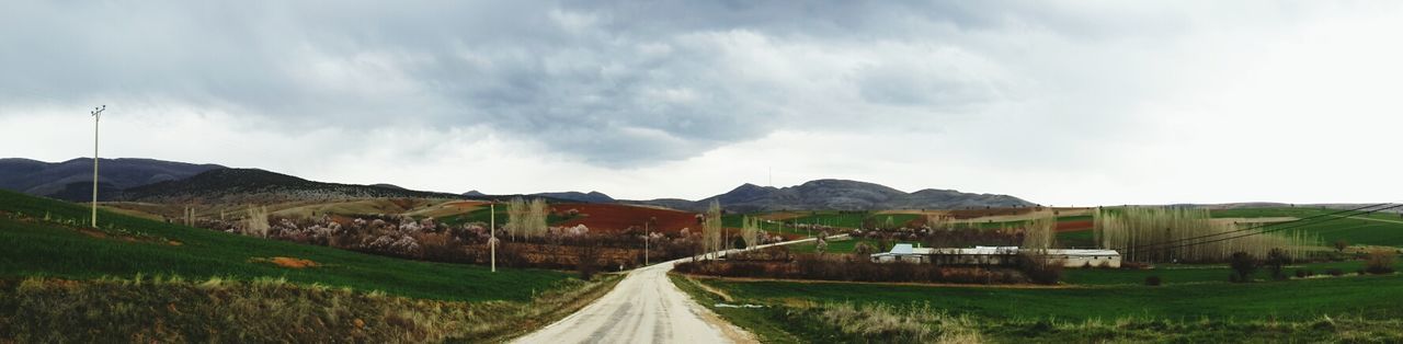 Panoramic shot of farm against cloudy sky