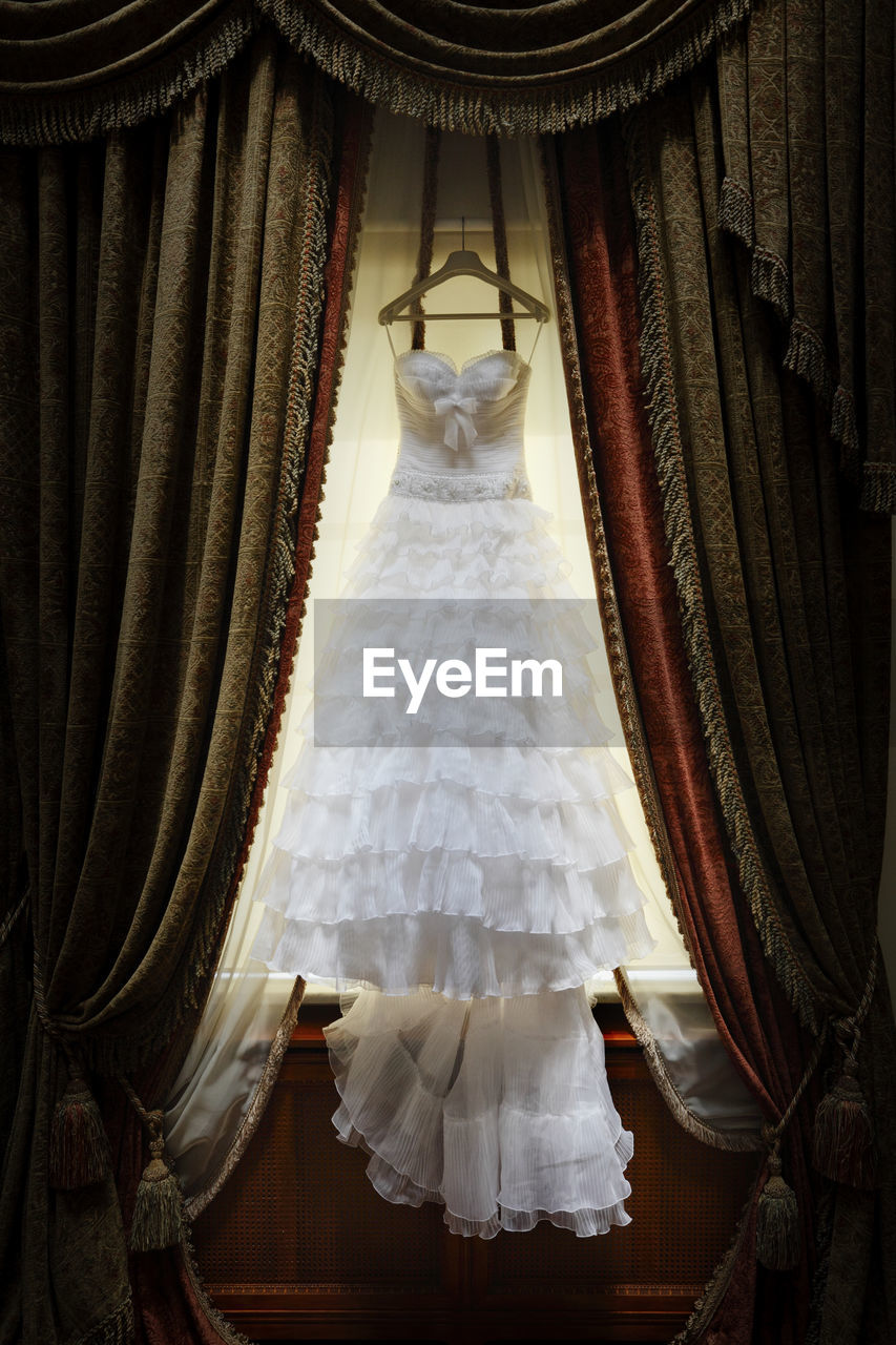 Wedding dress hanging indoors