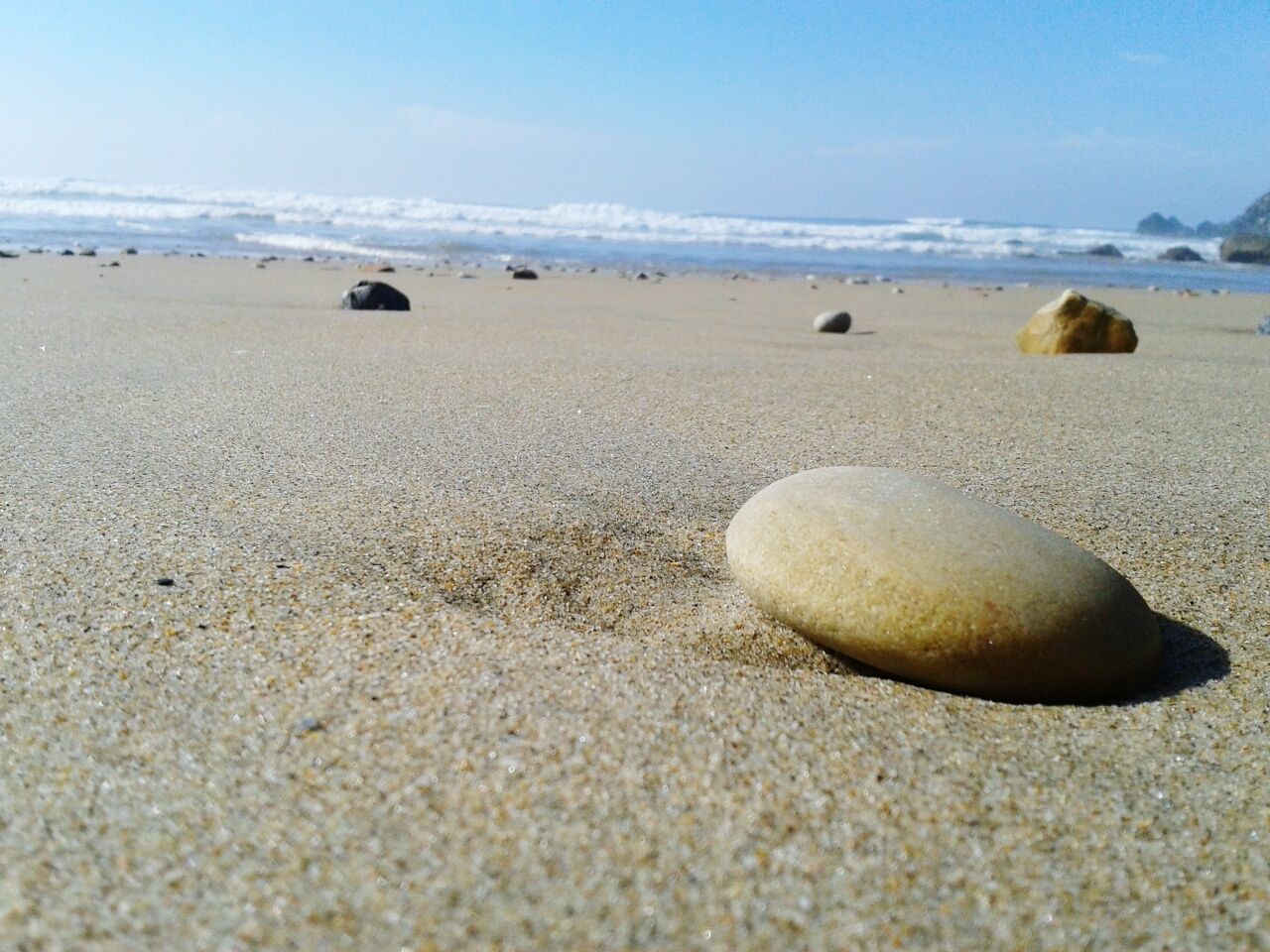 Scenic view of beach against clear sky