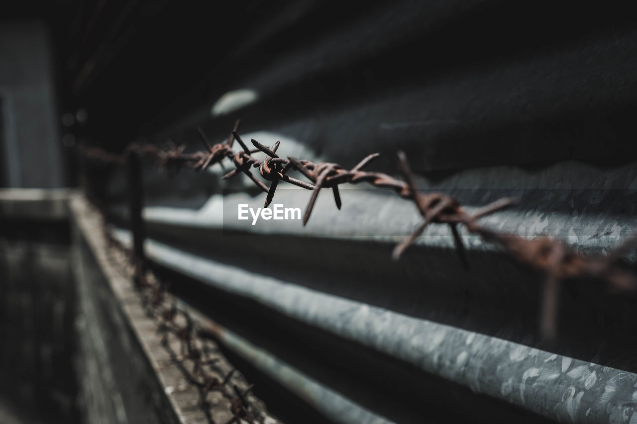 Rusty barbed wire at night