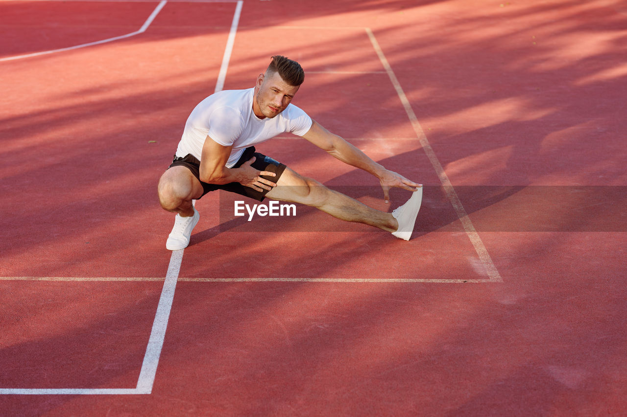 high angle view of boy playing soccer at court