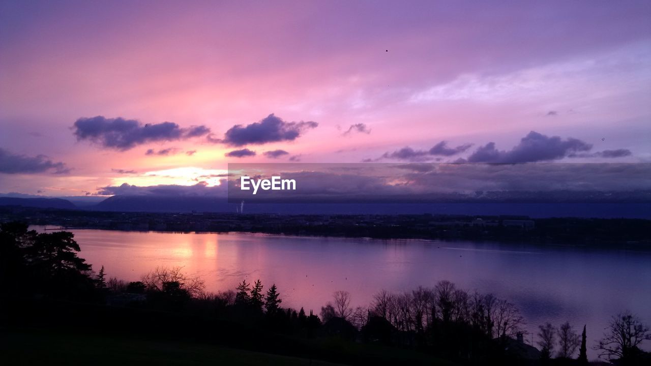 Moody sky above river at dusk