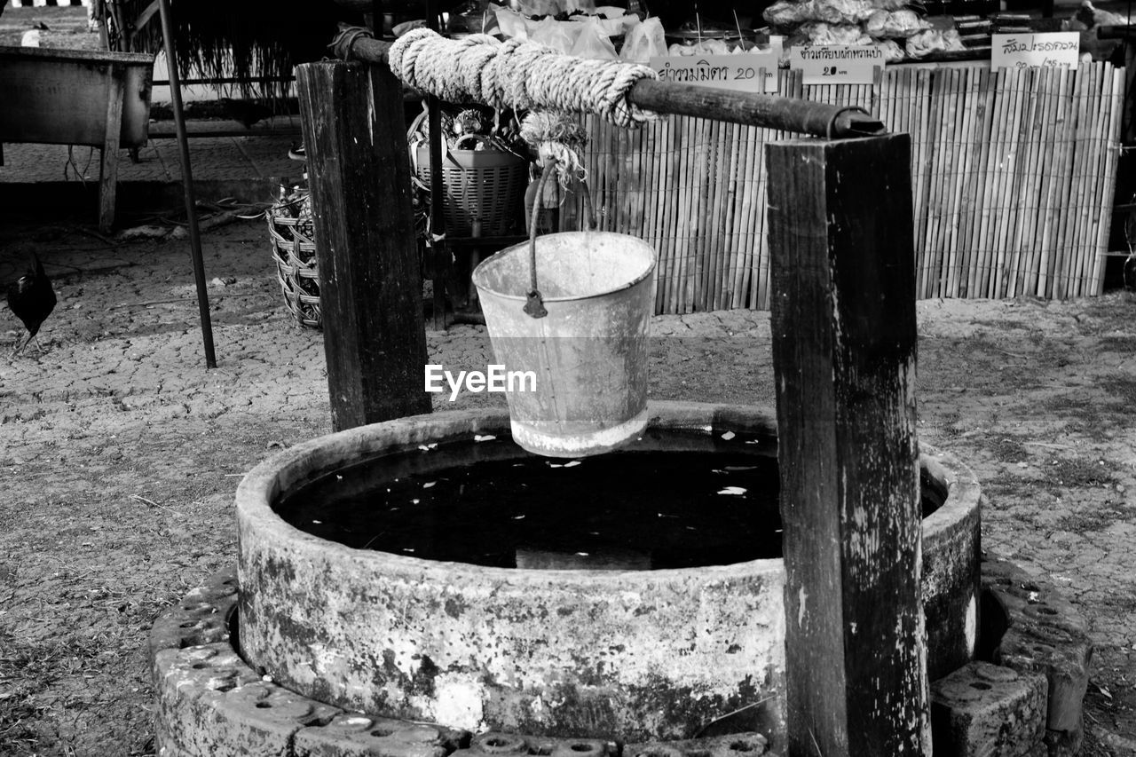 WOODEN POSTS AT WATER