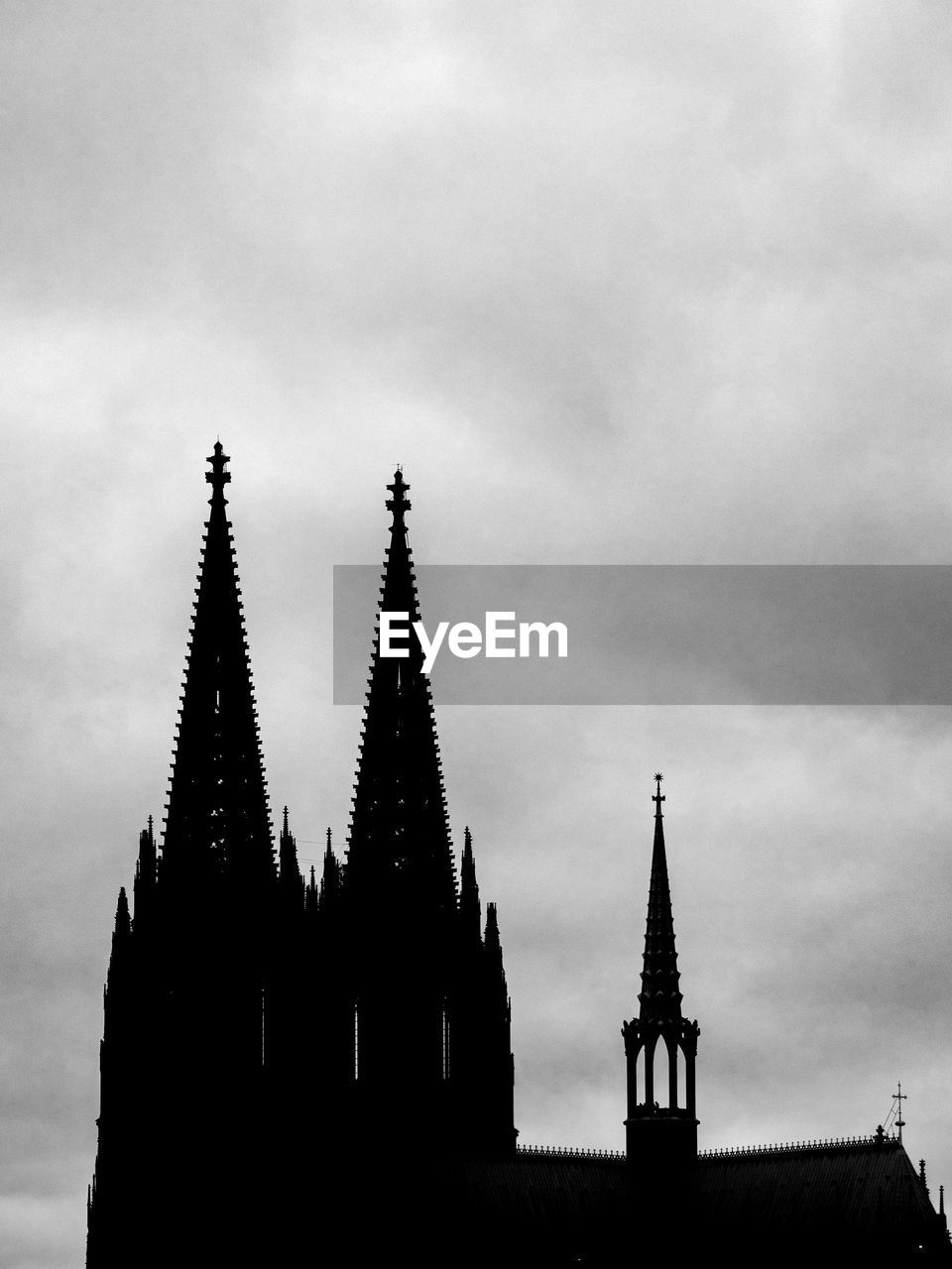 architecture, black and white, built structure, sky, building exterior, monochrome, monochrome photography, spire, cloud, building, tower, travel destinations, religion, no people, nature, history, steeple, the past, place of worship, belief, black, low angle view, silhouette, outdoors, city, white, travel, spirituality