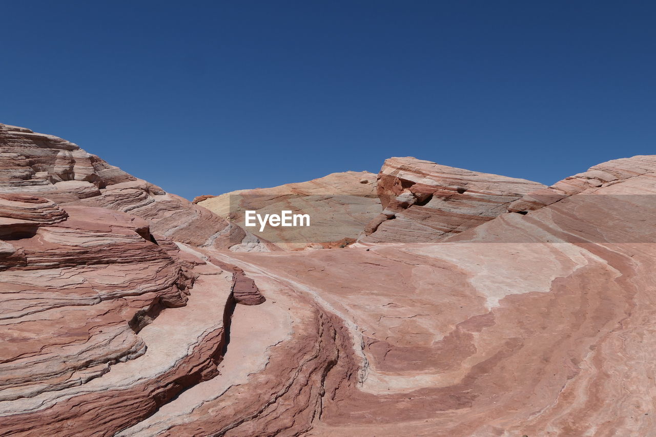 Rock formations against clear blue sky