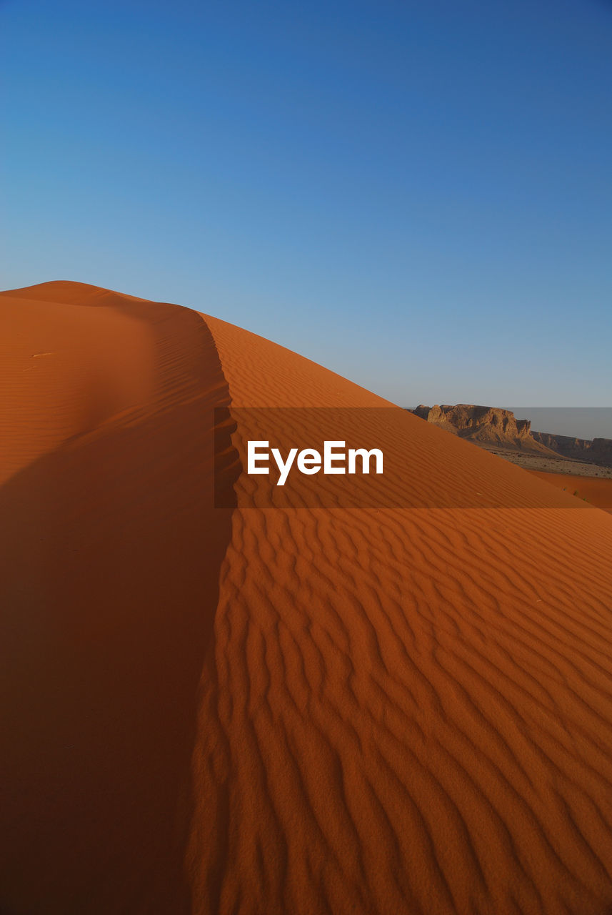 Scenic view of desert against clear sky