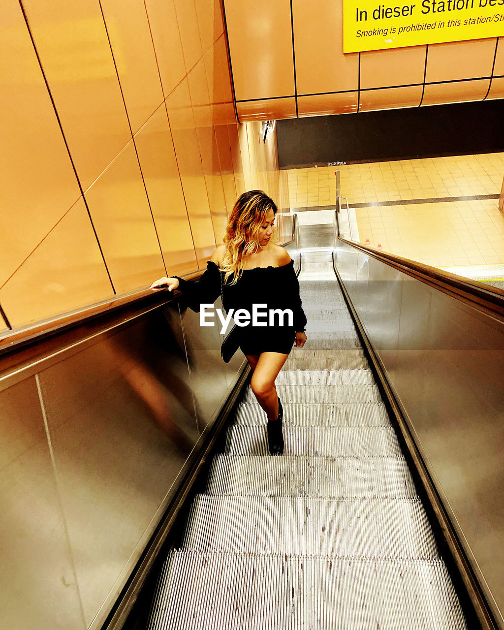 High angle view of woman standing on staircase