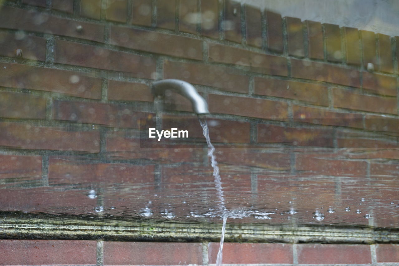 CLOSE-UP OF WET BRICK WALL