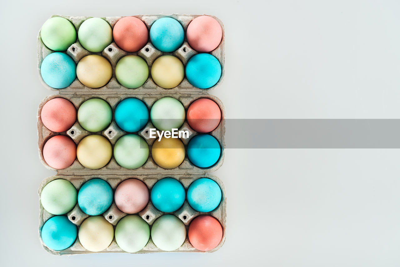 high angle view of multi colored macaroons against white background