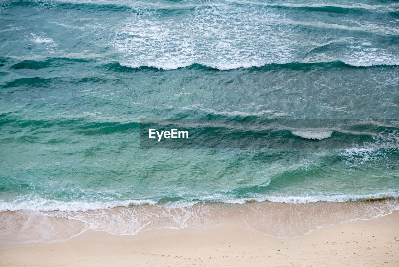 Full frame shot of sea waves. high angle view of cristo rei backside beach in dili, timor leste. 