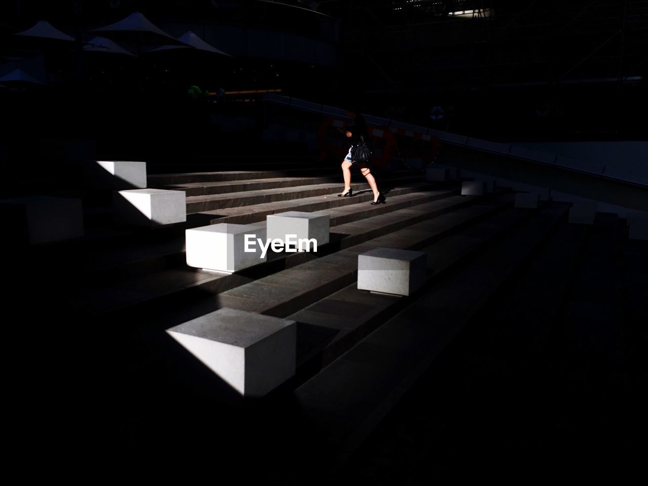 Low angle view of woman moving up staircase